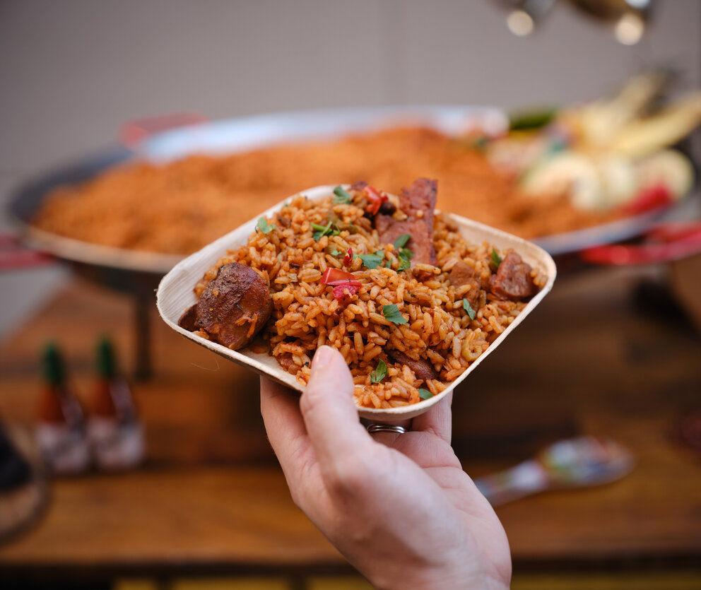 Someone holding a plate of jambalaya