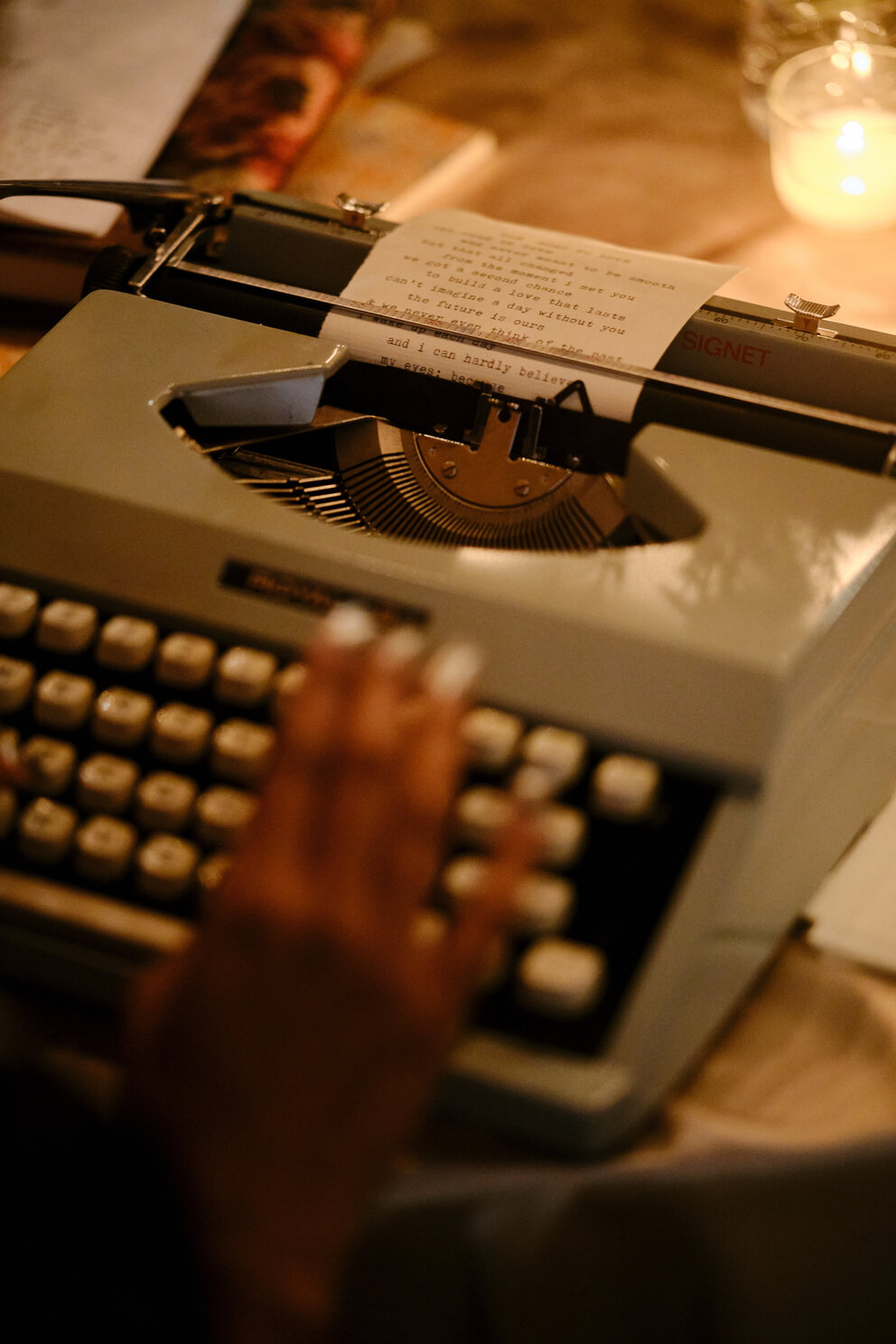 a person typing on a typewriter