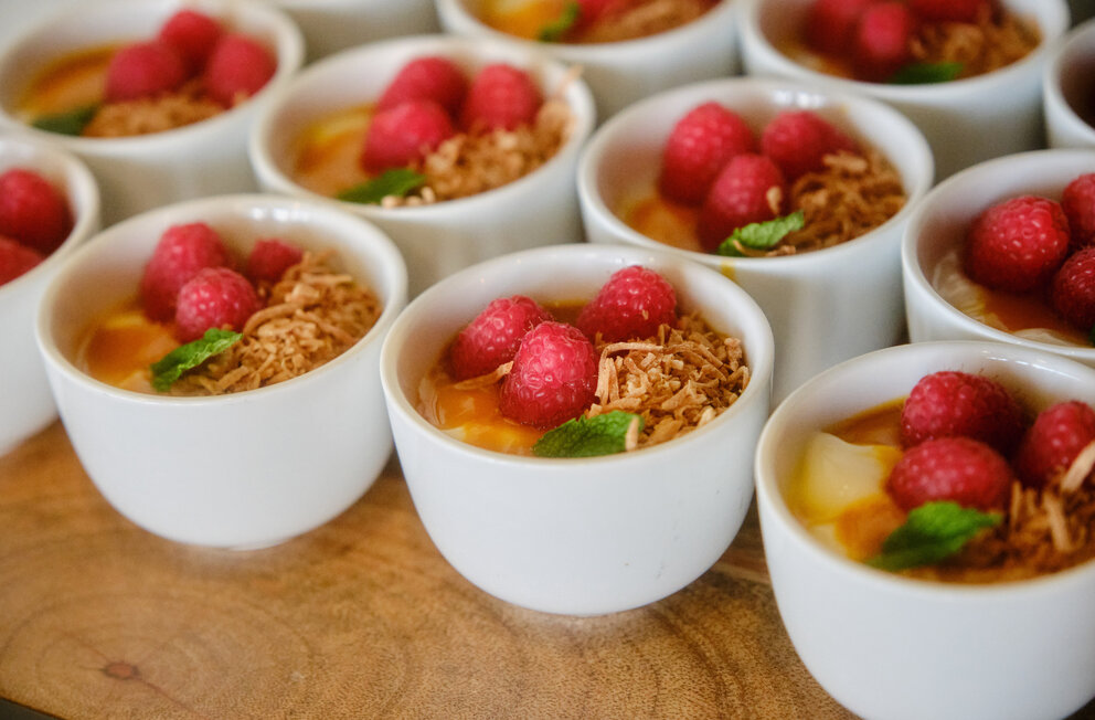 a group of white cups with fruit in them